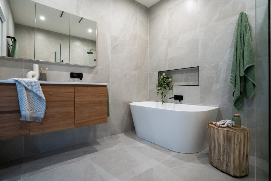 Modern bathroom with timber floating vanity, freestanding bath and mirrored cabinet