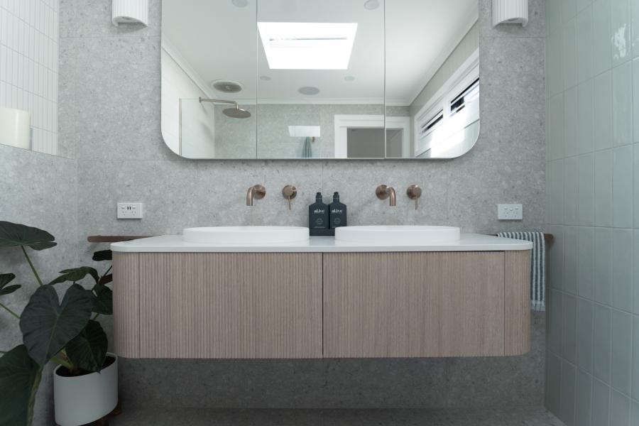 Modern bathroom with floating timber vanity, white basin and black tapware