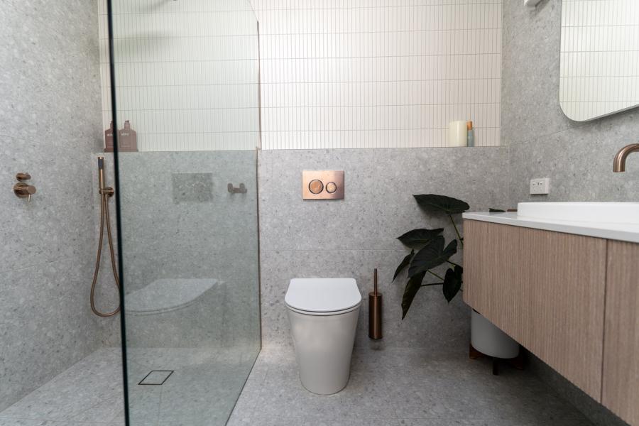 Modern bathroom with walk-in glass shower, wall-hung vanity and concealed cistern toilet