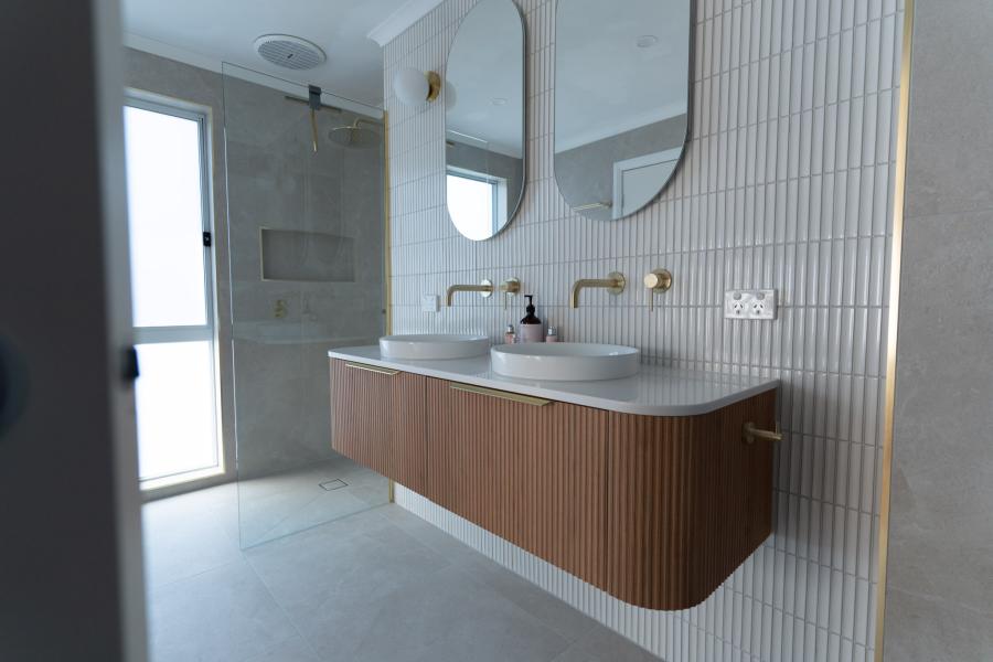 Modern bathroom with floating timber vanity, twin basins and walk-in shower