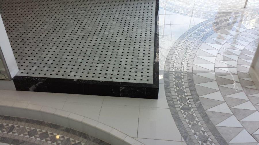 Decorative tiled floor with circular geometric mosaic in a bathroom or showroom setting