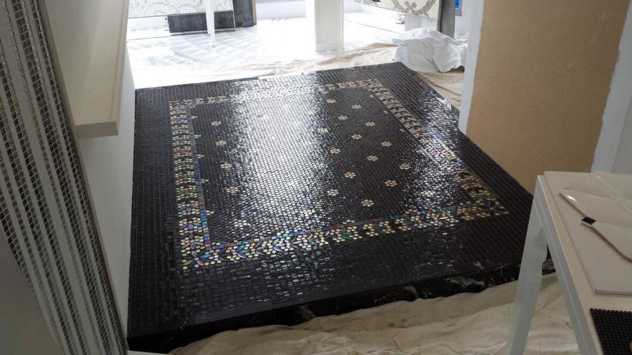 Black decorative floor tiling feature laid in an entryway during renovation work