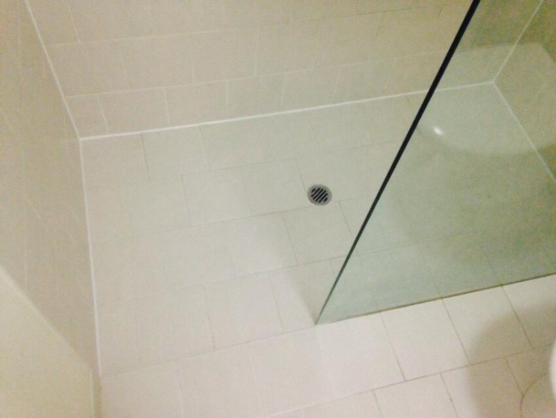 Modern bathroom shower niche with white tiles and black trim
