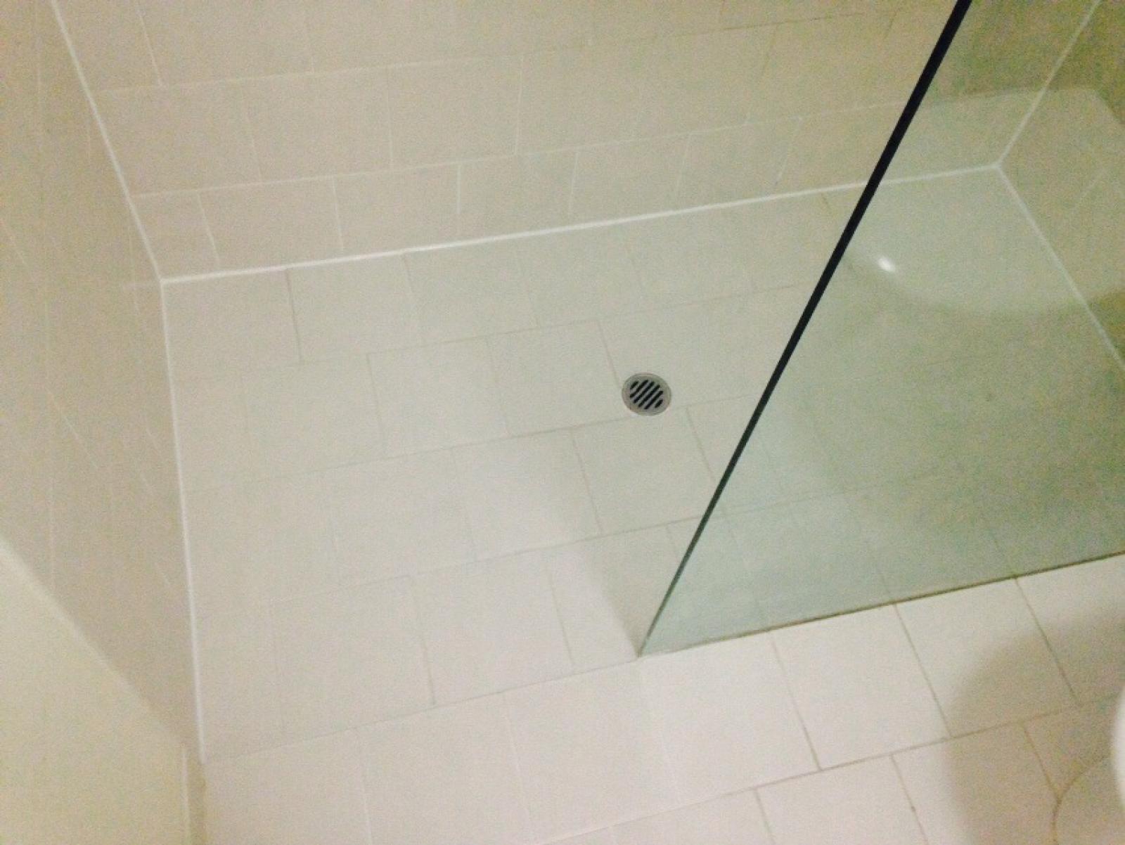 Modern bathroom shower niche with white tiles and black trim