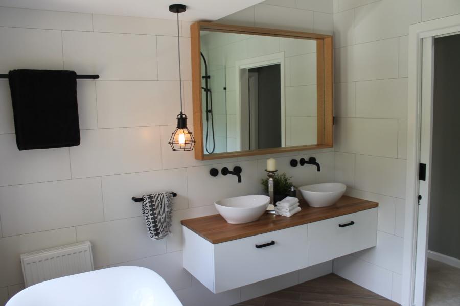 Modern white bathroom vanity with timber top, round basin, mirror and pendant light
