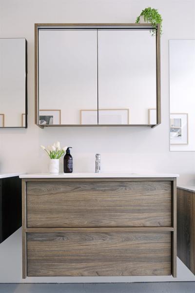 Wall-hung timber vanity with mirrored cabinet in a modern white bathroom