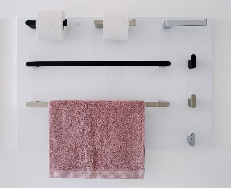 Bathroom accessories display with black and brushed metal towel rails, hooks and toilet roll holder