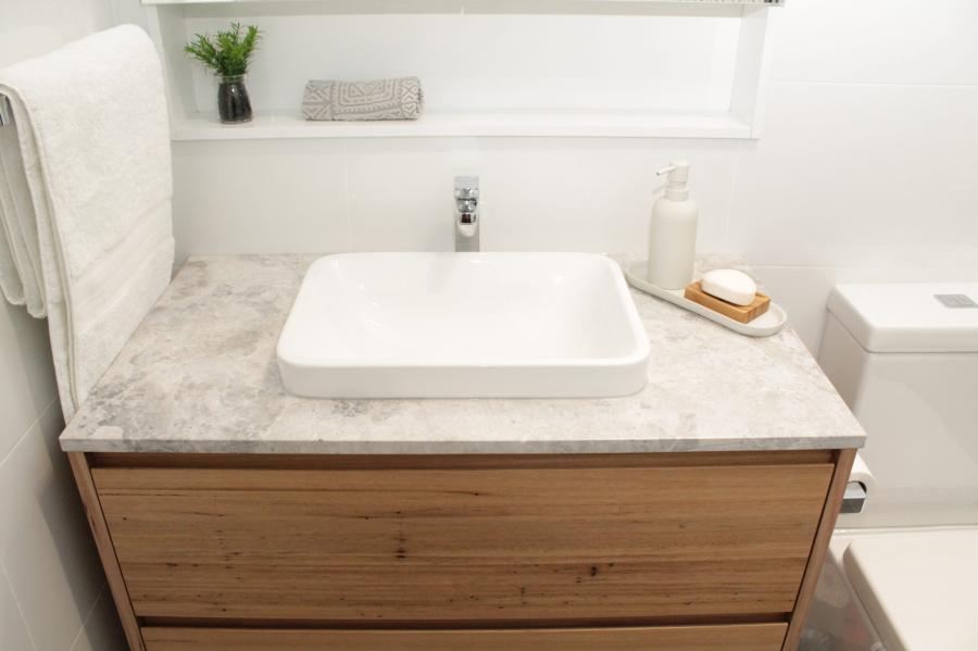 Modern bathroom vanity with timber drawers, stone benchtop and vessel basin