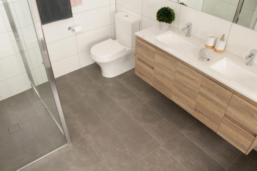 Modern bathroom with timber double vanity, walk-in shower and grey floor tiles