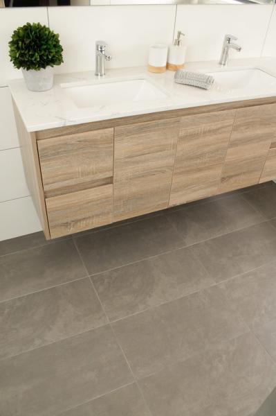 Modern double vanity with timber-look cabinetry, white benchtop and grey bathroom floor tiles
