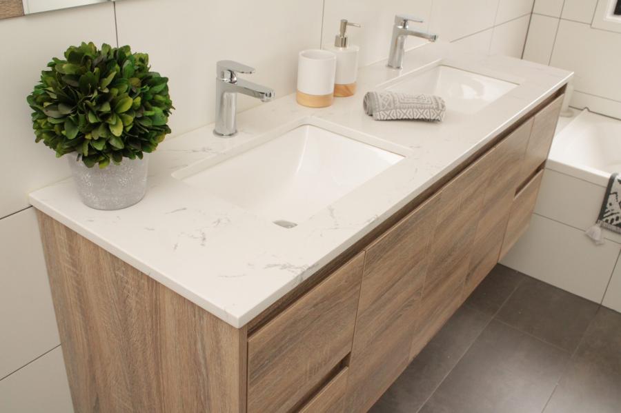 Timber double vanity with white basin top and chrome tapware in a modern bathroom