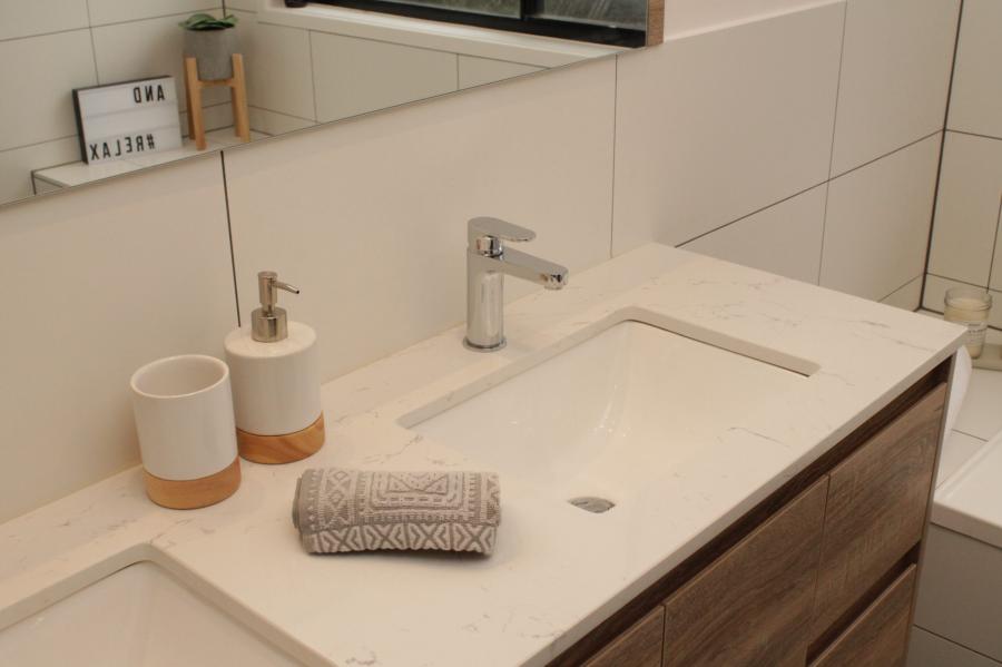 Modern bathroom vanity with integrated basin, timber drawers and chrome tapware