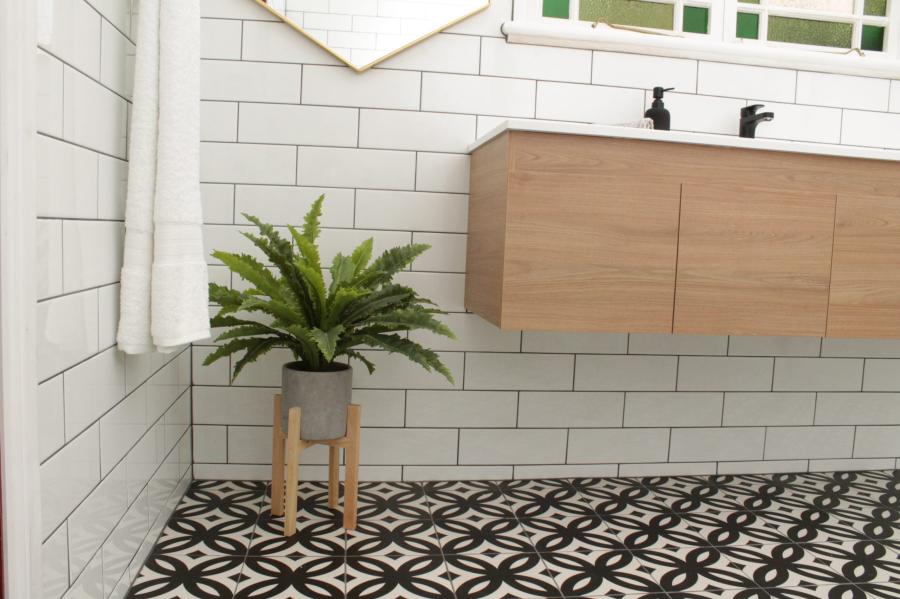 Modern bathroom with floating timber vanity, white subway tiles and patterned floor tiles