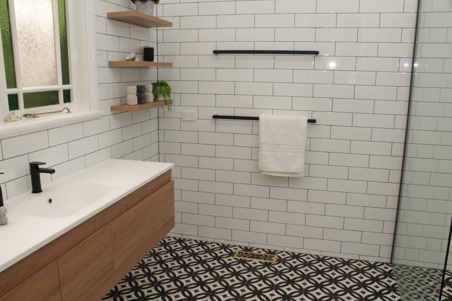 Modern bathroom with timber vanity, white subway tiles and patterned floor tiles