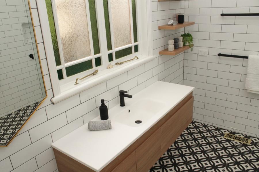 Modern bathroom vanity with white subway tiles, timber cabinetry and patterned floor tiles
