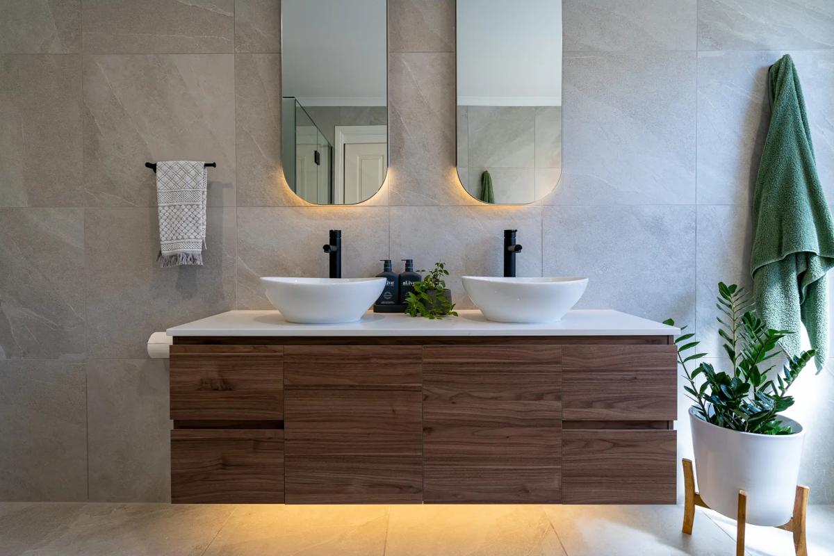Modern bathroom with floating timber vanity, double basins and arched mirrors