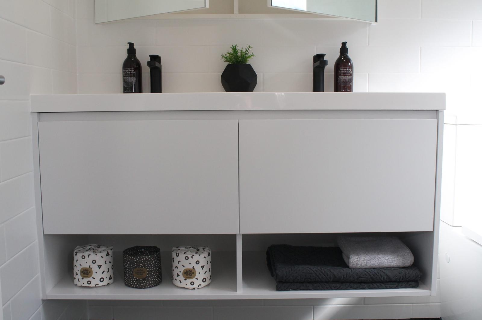 Modern white bathroom vanity with storage and accessories