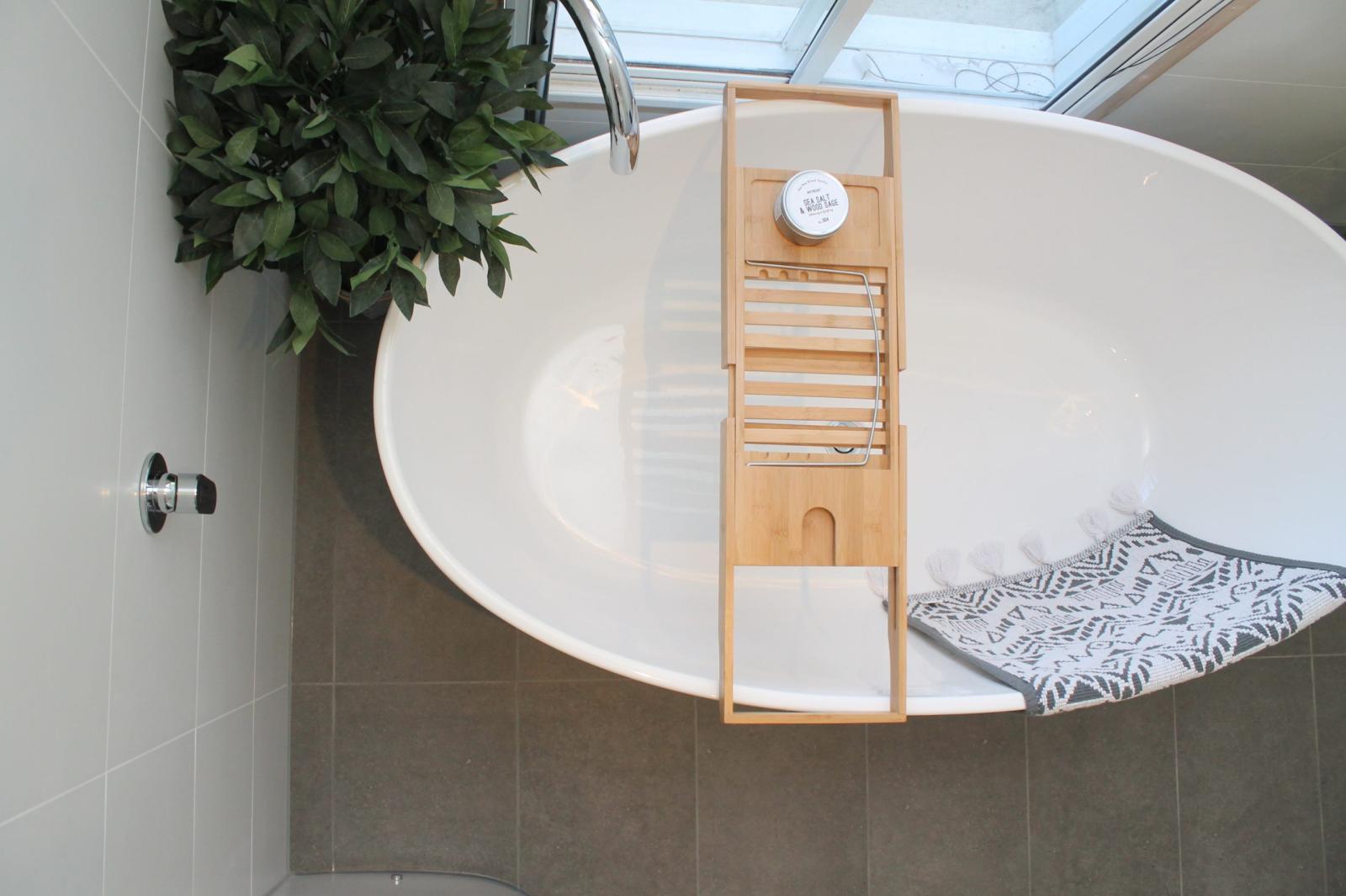 Modern bathroom with freestanding bath and wooden towel rail