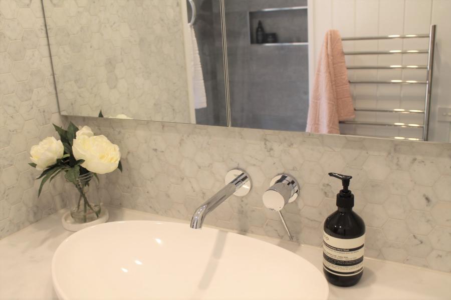 Modern bathroom vanity with vessel basin, mirrored cabinet and chrome tapware