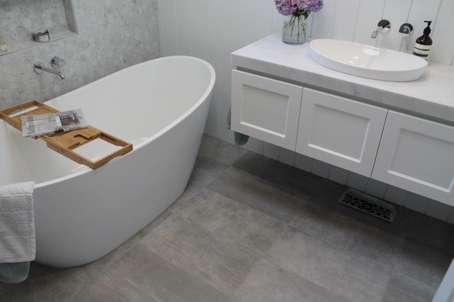 Modern white bathroom with freestanding bath and floating vanity