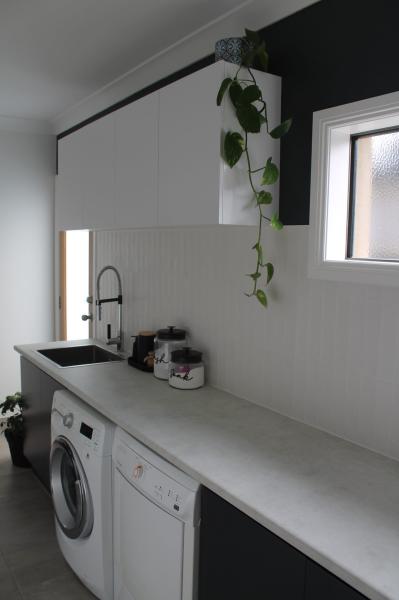 Modern laundry room with washing machine and sink