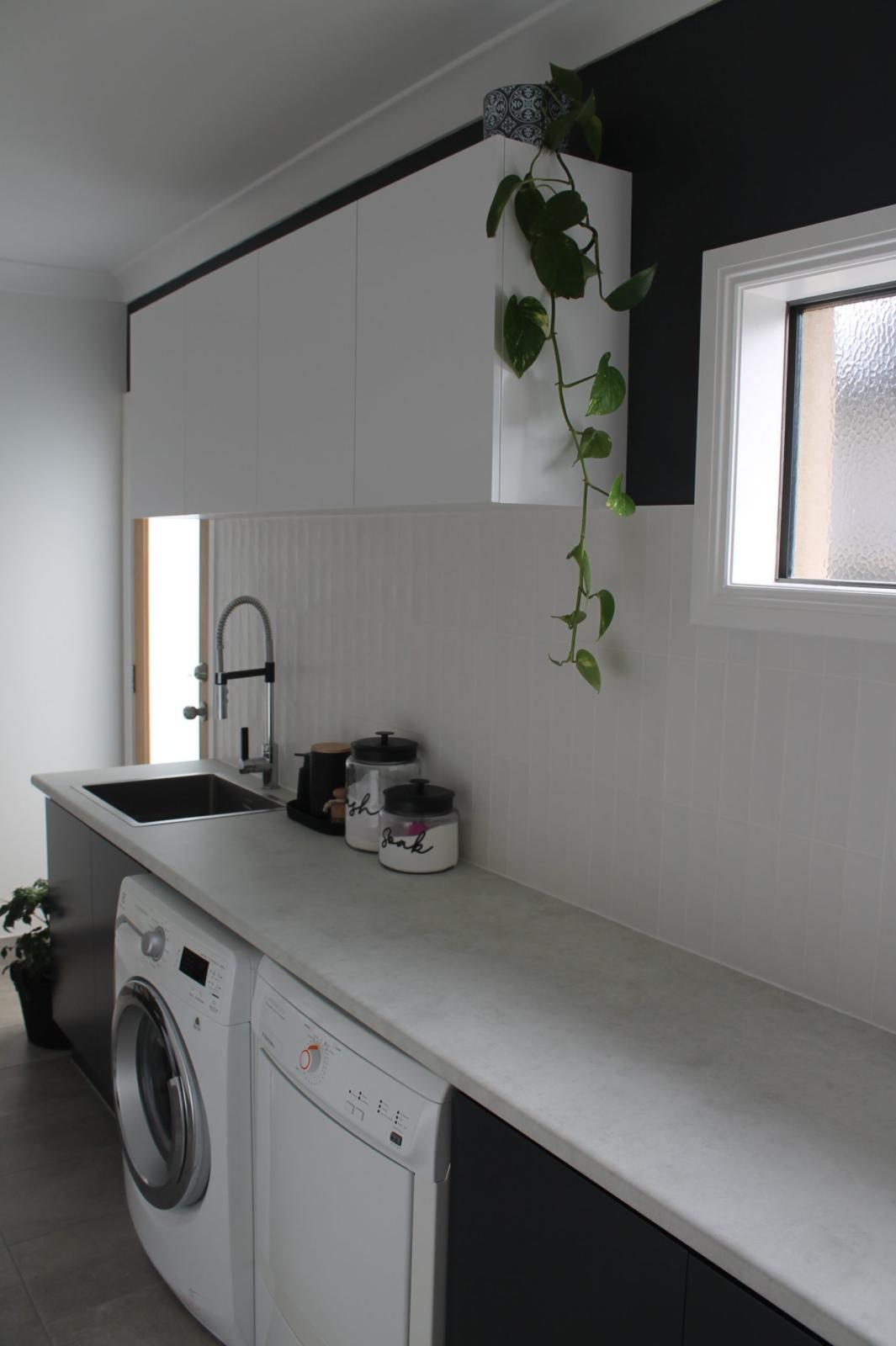 Modern laundry room with washing machine and sink