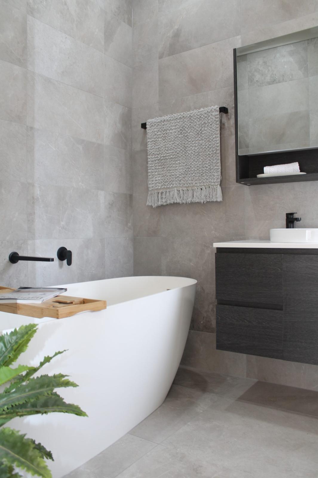 Modern bathroom with freestanding bath and black tapware
