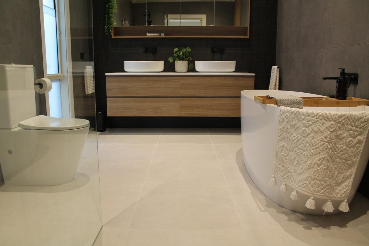 Modern bathroom with double vanity, freestanding bath and toilet
