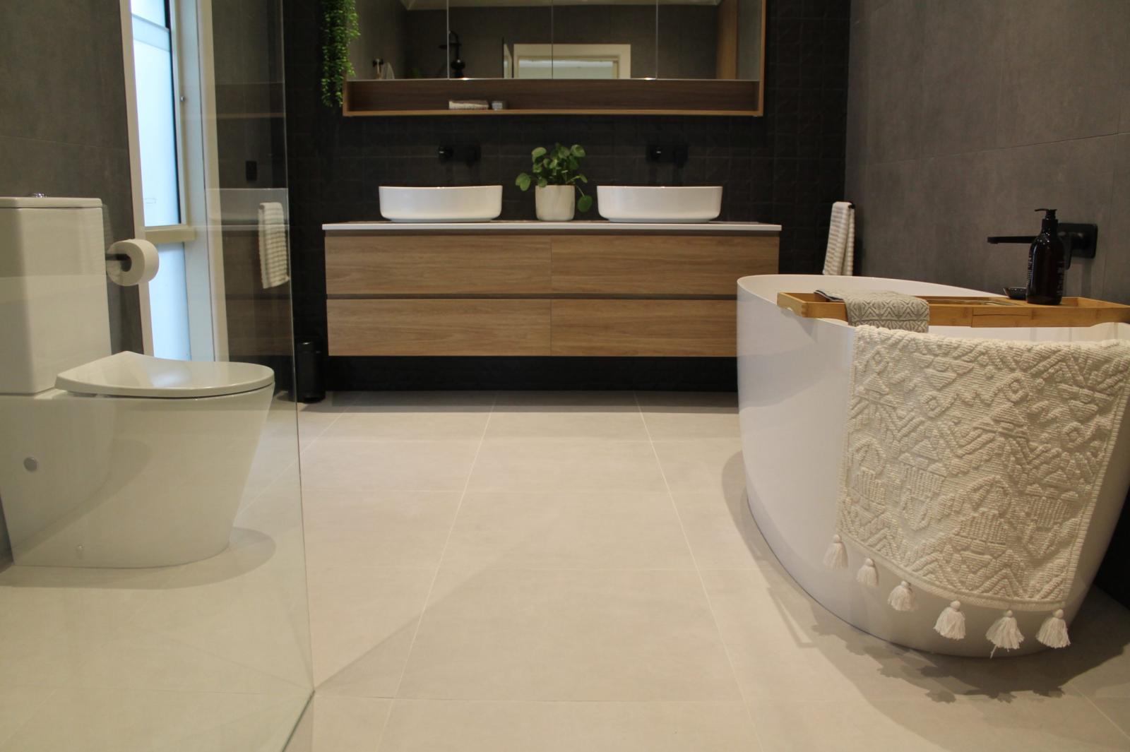 Modern bathroom with double vanity, freestanding bath and toilet