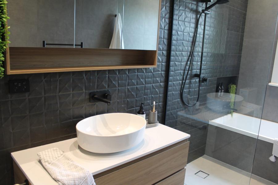 Modern grey bathroom with vessel basin, timber vanity, mirror cabinet and glass shower over bath