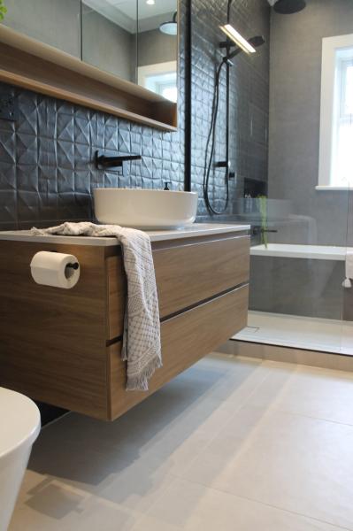 Modern bathroom with timber floating vanity, vessel basin and glass shower over bath