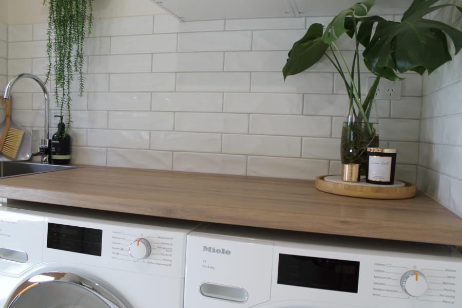 Modern laundry room with white subway tile splashback