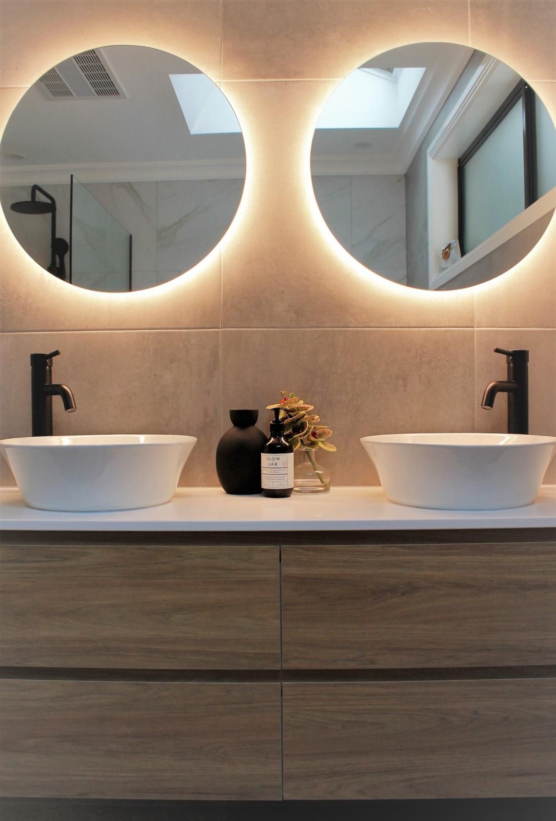 Modern double vanity bathroom with LED illuminated mirrors