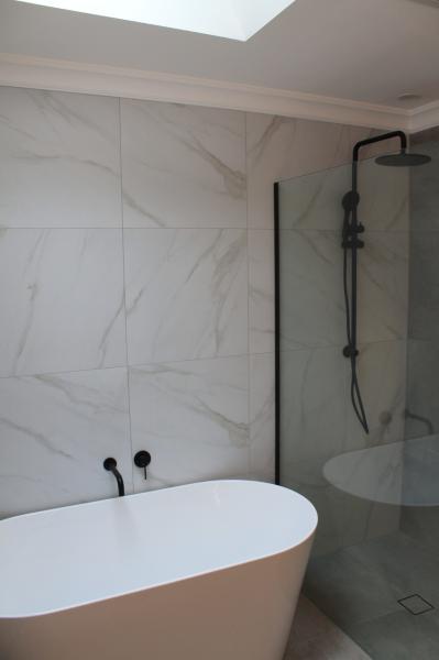 Modern bathroom with freestanding bath and glass walk-in shower