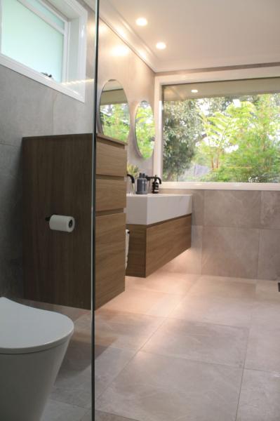 Modern bathroom with timber vanity, walk-in shower and large window