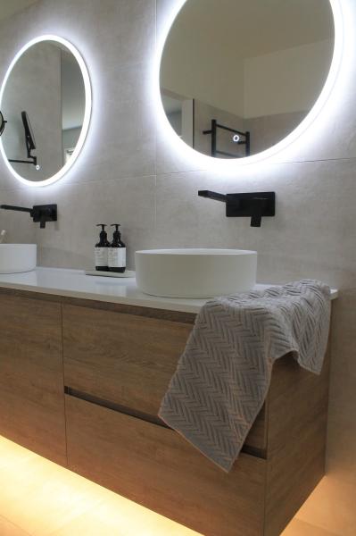 Modern bathroom vanity with dual LED illuminated mirrors and black tapware