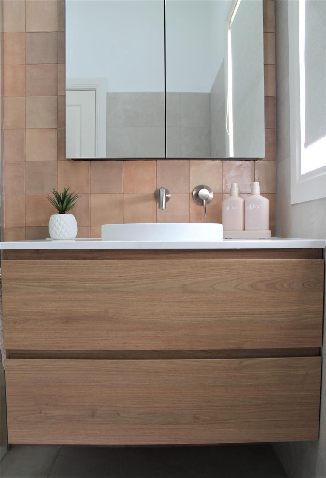 Modern bathroom vanity with timber cabinetry and terracotta tiles