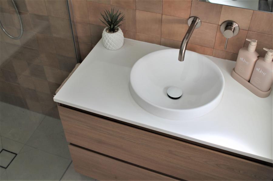 Modern bathroom vanity with round basin, timber cabinetry and chrome tapware