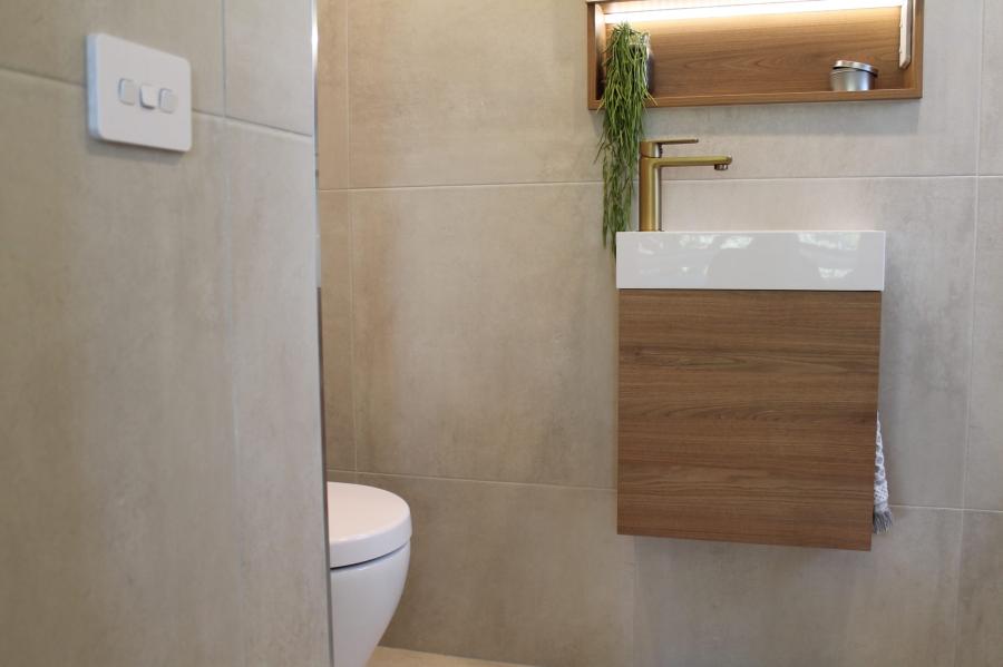Compact modern bathroom with wall-hung vanity, basin and concealed toilet