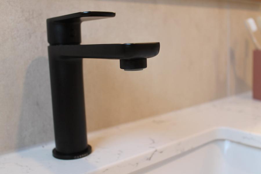 Matte black bathroom basin tap on a white vanity sink