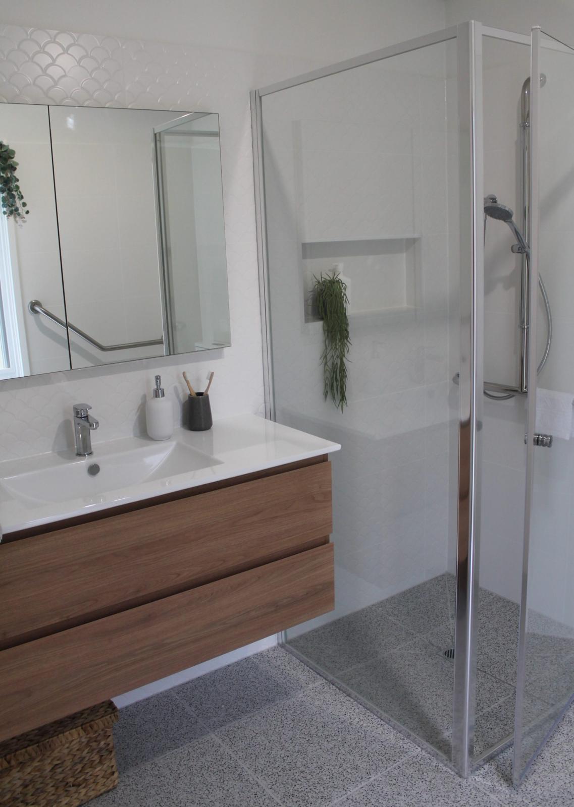 Modern bathroom with timber vanity and glass shower enclosure