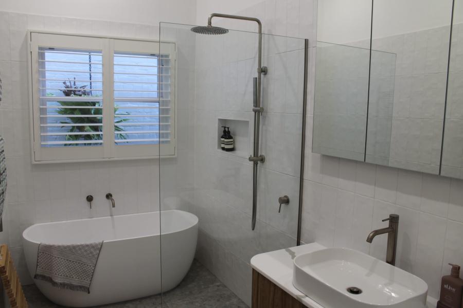 Modern white bathroom with freestanding bath, walk-in shower and vanity