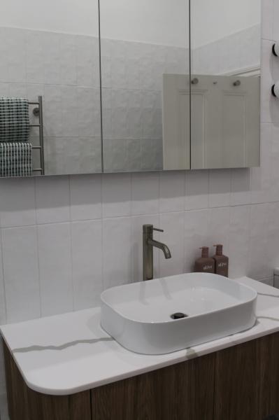 Modern bathroom vanity with vessel basin, mirrored cabinet and chrome tapware