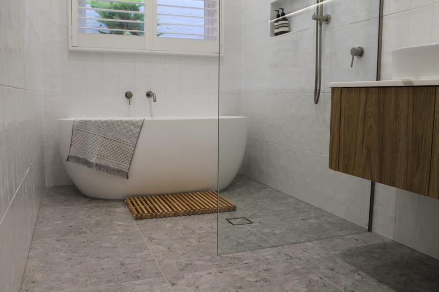 Modern white bathroom with freestanding bath, walk-in shower and timber vanity