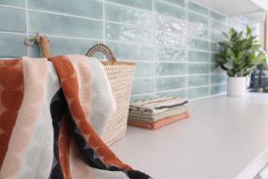 Bathroom vanity with towels, basket, and plant decoration