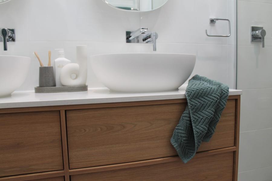 Modern bathroom vanity with vessel basins, timber drawers and white wall tiles