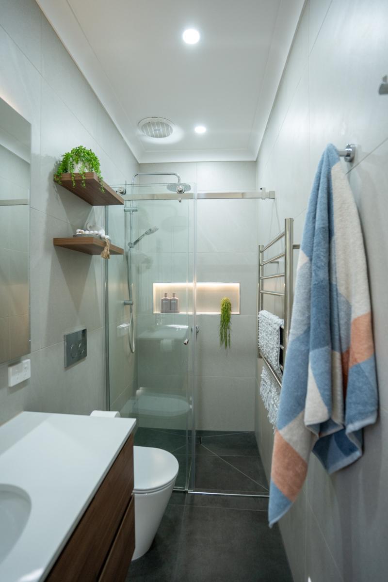 Modern ensuite bathroom with walk-in shower and white tiles