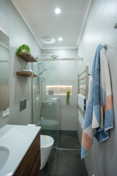 Modern ensuite bathroom with walk-in shower and white tiles