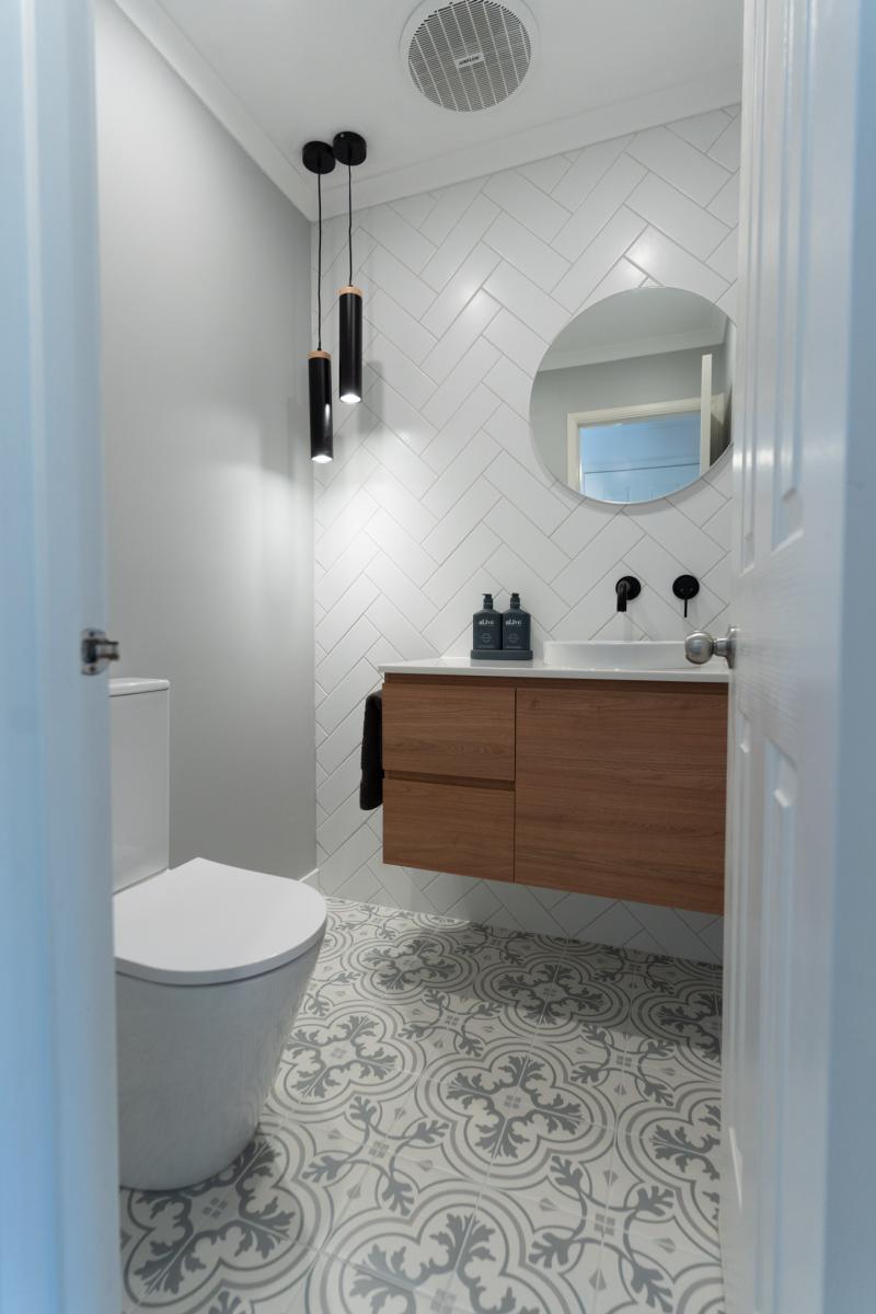 Modern bathroom with timber vanity and herringbone tiles