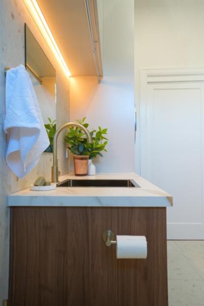 Modern bathroom vanity with sink, timber cabinet, wall mirror and towel rail